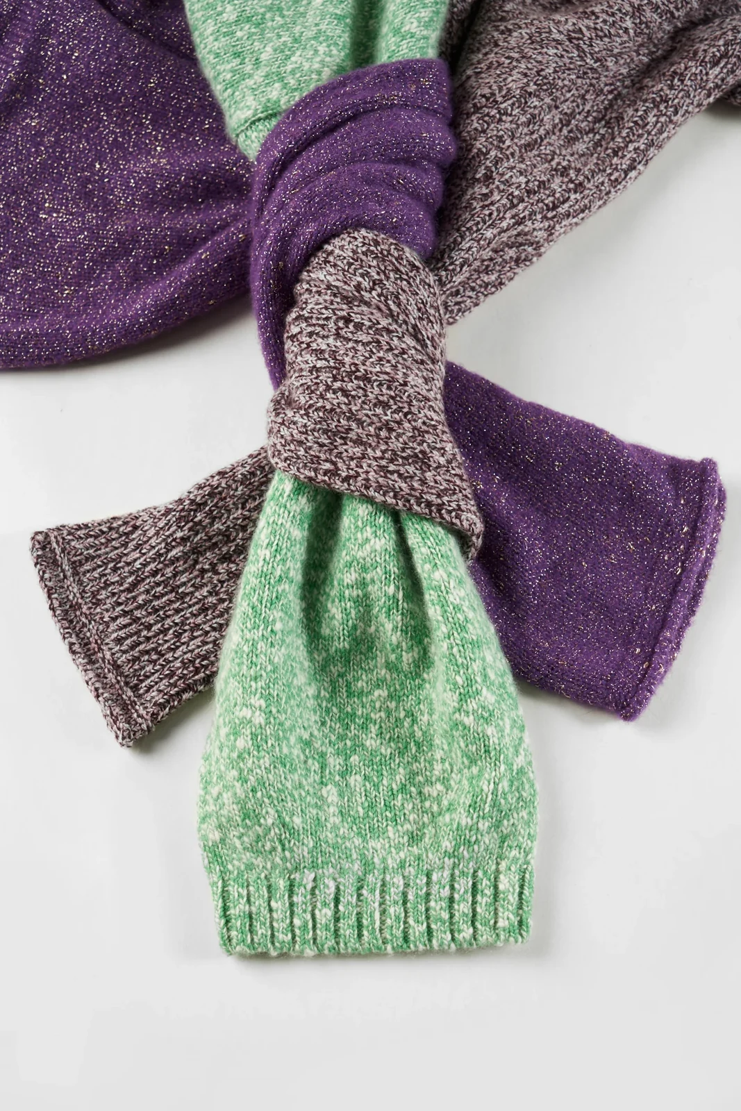 Purple, green and grey knitted scarves